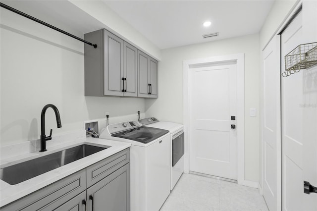 1527 Buoy Ln, Osprey, FL 34229 - laundry room with washing machine and clothes dryer, cabinet space, light tile patterned floors, and recessed lighting