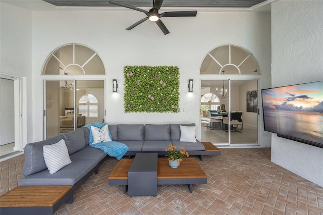 1527 Buoy Ln, Osprey, FL 34229 - living area featuring a ceiling fan, a high ceiling, brick flooring, and a chandelier