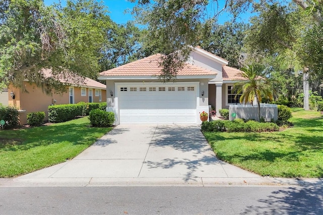 4121 Reflections Pkwy, Sarasota, FL 34233 - view of front of home with a garage, stucco siding, concrete driveway, and a front lawn