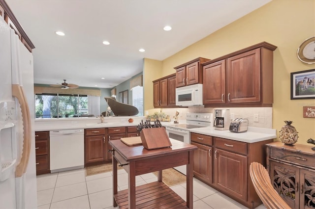 4121 Reflections Pkwy, Sarasota, FL 34233 - kitchen featuring white appliances, a ceiling fan, tasteful backsplash, light countertops, and recessed lighting
