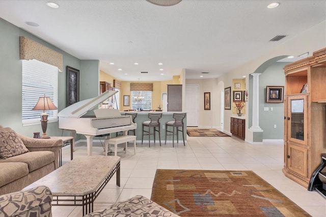 4121 Reflections Pkwy, Sarasota, FL 34233 - living area with ornate columns, arched walkways, light tile patterned floors, recessed lighting, and baseboards