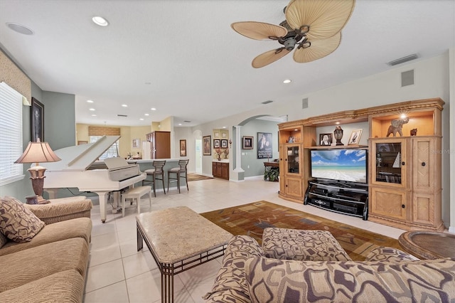 4121 Reflections Pkwy, Sarasota, FL 34233 - living area with arched walkways, ceiling fan, light tile patterned floors, baseboards, and recessed lighting