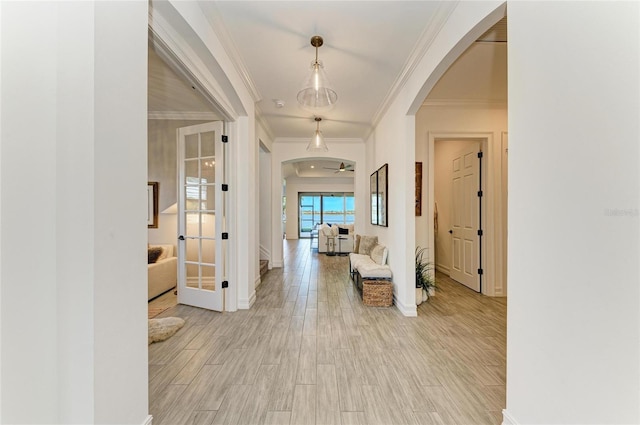 501 Maraviya Blvd, Nokomis, FL 34275 - corridor featuring arched walkways, crown molding, light wood-style floors, baseboards, and french doors