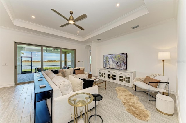 501 Maraviya Blvd, Nokomis, FL 34275 - living room featuring a tray ceiling, ceiling fan, light wood-style floors, and crown molding