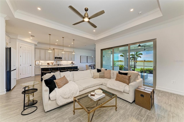 501 Maraviya Blvd, Nokomis, FL 34275 - living area featuring ceiling fan, a tray ceiling, light wood-style floors, recessed lighting, and ornamental molding