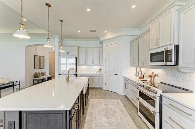 501 Maraviya Blvd, Nokomis, FL 34275 - kitchen featuring white appliances, arched walkways, a sink, decorative backsplash, and recessed lighting