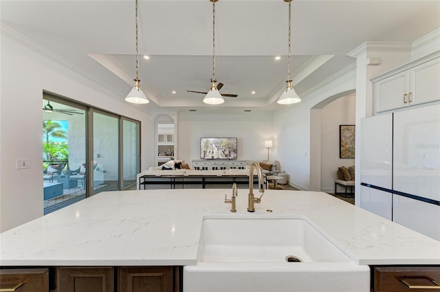 501 Maraviya Blvd, Nokomis, FL 34275 - kitchen with arched walkways, a sink, crown molding, ceiling fan, and open floor plan