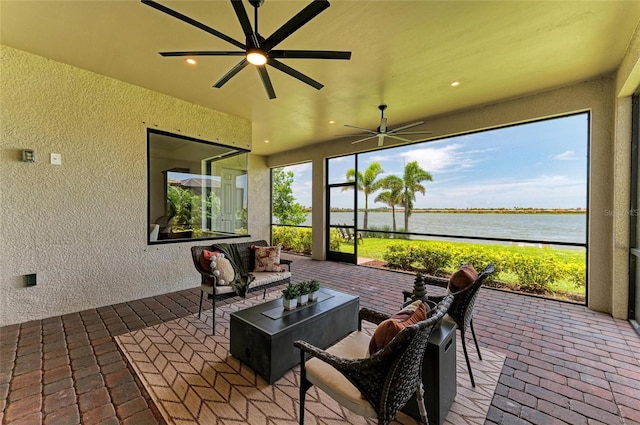 501 Maraviya Blvd, Nokomis, FL 34275 - sunroom featuring a textured wall, a water view, brick flooring, ceiling fan, and recessed lighting