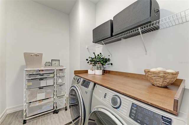 501 Maraviya Blvd, Nokomis, FL 34275 - laundry area featuring washing machine and dryer, wood finished floors, and baseboards