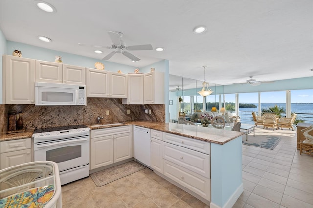 4310 Falmouth Dr Unit 307, Longboat Key, FL 34228 - kitchen with white appliances, ceiling fan, a peninsula, backsplash, and recessed lighting