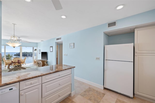 4310 Falmouth Dr Unit 307, Longboat Key, FL 34228 - kitchen with white appliances, white cabinets, light stone countertops, ceiling fan, and baseboards