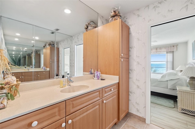 4310 Falmouth Dr Unit 307, Longboat Key, FL 34228 - ensuite bathroom with wallpapered walls, vanity, and recessed lighting
