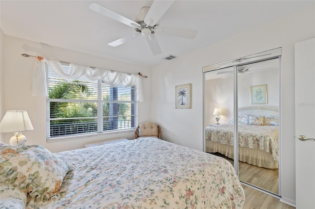 4310 Falmouth Dr Unit 307, Longboat Key, FL 34228 - bedroom with light wood-style flooring, a ceiling fan, and a closet