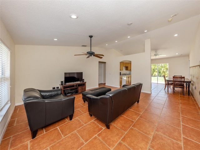 3698 N Chamberlain Blvd, North Port, FL 34286 - living room with ceiling fan, arched walkways, lofted ceiling, recessed lighting, and light tile patterned floors