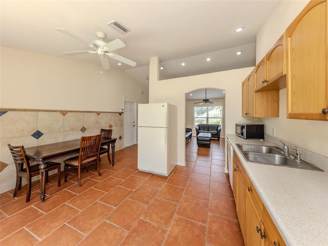 3698 N Chamberlain Blvd, North Port, FL 34286 - kitchen with freestanding refrigerator, a ceiling fan, stainless steel microwave, light brown cabinets, and a sink