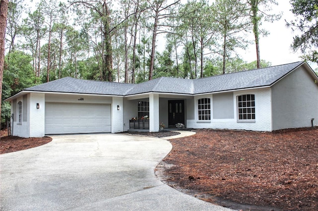 27944 Green Willow Run, Wesley Chapel, FL 33544 - ranch-style home with brick siding, a garage, roof with shingles, and concrete driveway