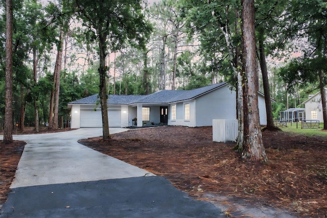 27944 Green Willow Run, Wesley Chapel, FL 33544 - ranch-style home featuring concrete driveway, a garage, stucco siding, and roof with shingles