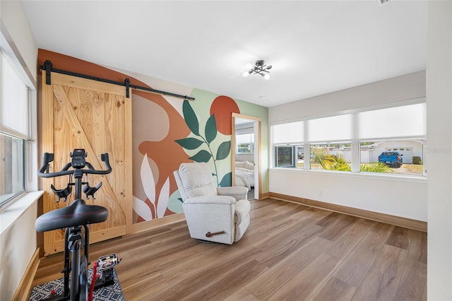 440 42nd St N, Saint Petersburg, FL 33713 - living area featuring wood finished floors, baseboards, and a barn door