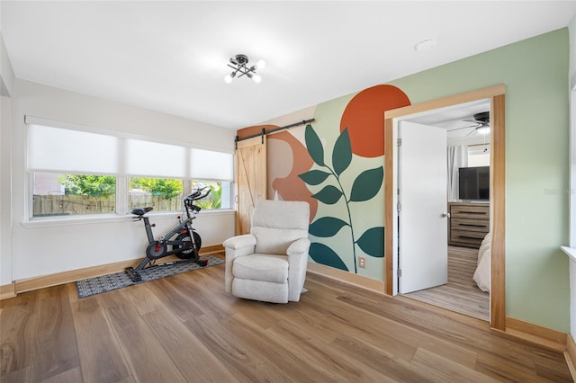 440 42nd St N, Saint Petersburg, FL 33713 - living area featuring baseboards, wood finished floors, and a barn door