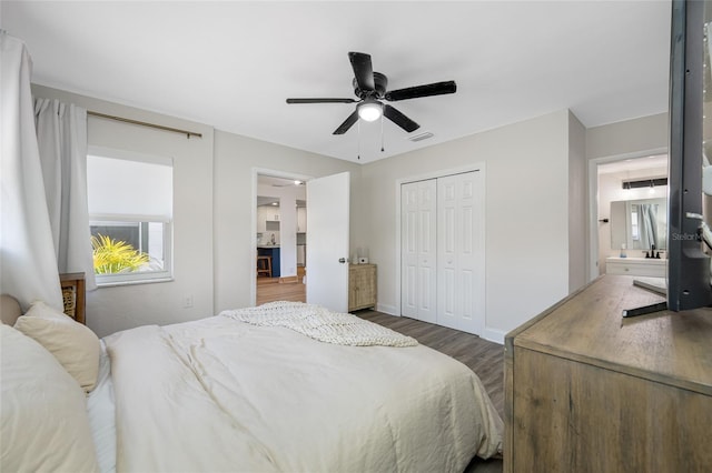 440 42nd St N, Saint Petersburg, FL 33713 - bedroom featuring dark wood-type flooring, a closet, multiple windows, and baseboards