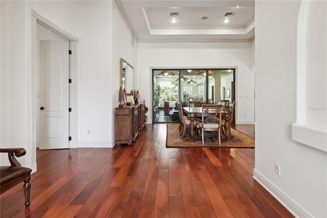 4696 Del Sol Blvd, Sarasota, FL 34243 - dining area with a tray ceiling, dark wood-type flooring, ornamental molding, and baseboards
