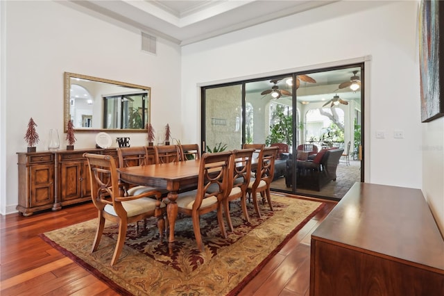 4696 Del Sol Blvd, Sarasota, FL 34243 - dining room featuring dark wood-style floors, a ceiling fan, and ornamental molding