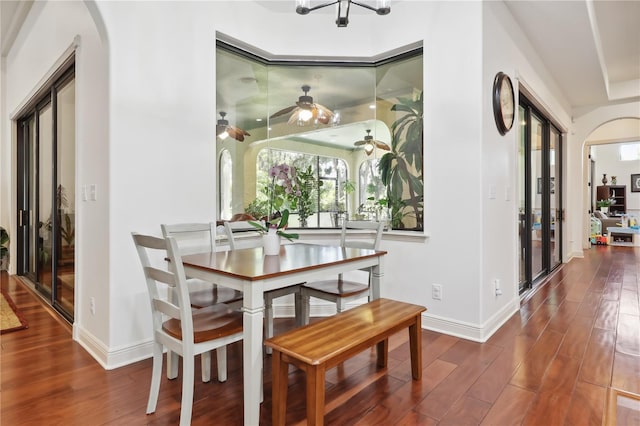 4696 Del Sol Blvd, Sarasota, FL 34243 - dining space featuring wood finished floors, arched walkways, baseboards, and a ceiling fan
