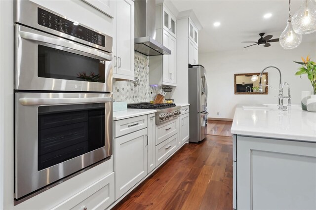 4696 Del Sol Blvd, Sarasota, FL 34243 - kitchen with appliances with stainless steel finishes, wall chimney exhaust hood, light countertops, recessed lighting, and decorative backsplash