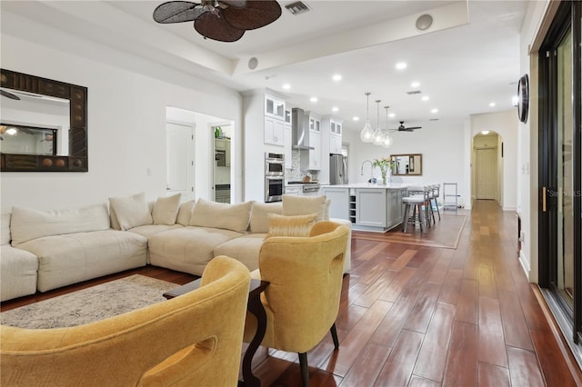 4696 Del Sol Blvd, Sarasota, FL 34243 - living area with a ceiling fan, dark wood-style floors, arched walkways, and recessed lighting