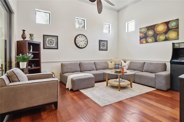 4696 Del Sol Blvd, Sarasota, FL 34243 - living area featuring ceiling fan, wood-type flooring, crown molding, and a towering ceiling