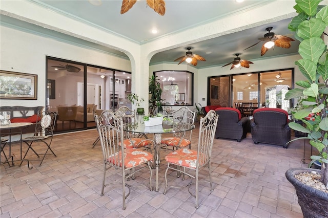 4696 Del Sol Blvd, Sarasota, FL 34243 - dining room with ornamental molding, ceiling fan, and arched walkways