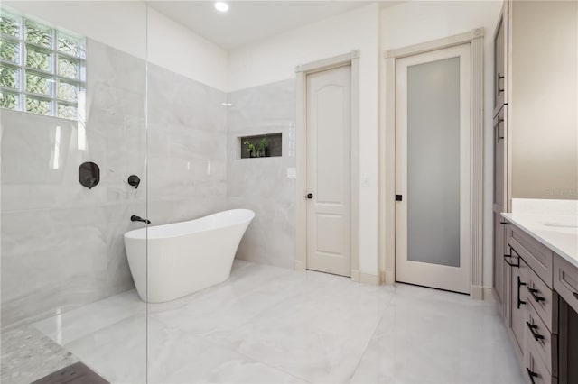 4696 Del Sol Blvd, Sarasota, FL 34243 - bathroom with vanity, a freestanding bath, a walk in shower, and recessed lighting