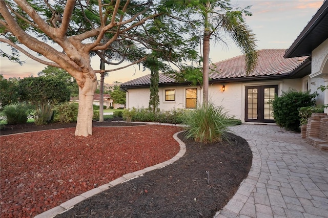 4696 Del Sol Blvd, Sarasota, FL 34243 - yard at dusk with french doors
