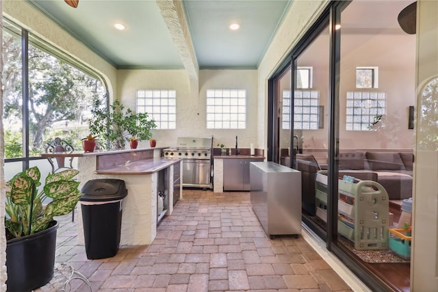 4696 Del Sol Blvd, Sarasota, FL 34243 - kitchen featuring brick floors, recessed lighting, a sink, and crown molding