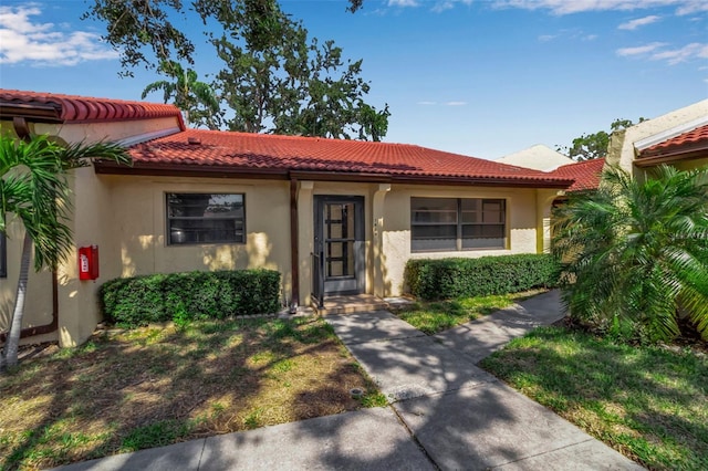 1409 57th St W Unit 1409, Bradenton, FL 34209 - view of front of home with a tiled roof and stucco siding