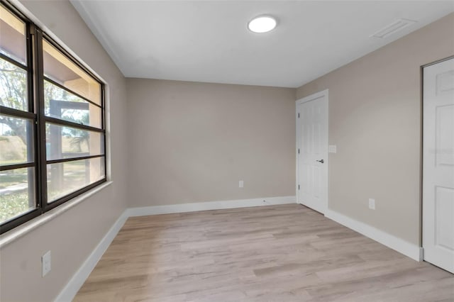 1409 57th St W Unit 1409, Bradenton, FL 34209 - spare room featuring light wood-style flooring and baseboards