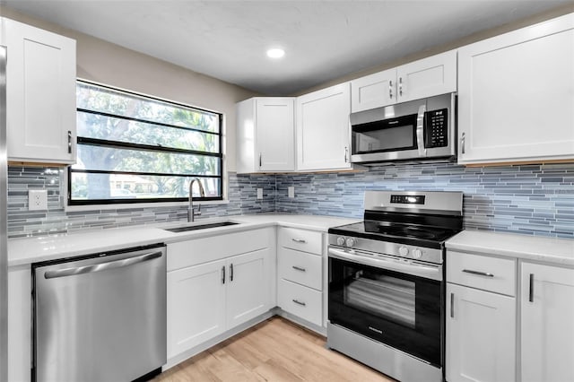 1409 57th St W Unit 1409, Bradenton, FL 34209 - kitchen featuring appliances with stainless steel finishes, light countertops, white cabinets, and recessed lighting