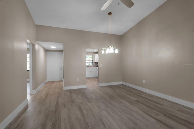1409 57th St W Unit 1409, Bradenton, FL 34209 - unfurnished dining area with a ceiling fan, light wood finished floors, and vaulted ceiling