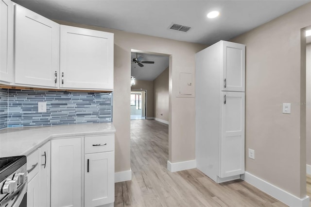 1409 57th St W Unit 1409, Bradenton, FL 34209 - kitchen with light wood-type flooring, ceiling fan, tasteful backsplash, light countertops, and lofted ceiling