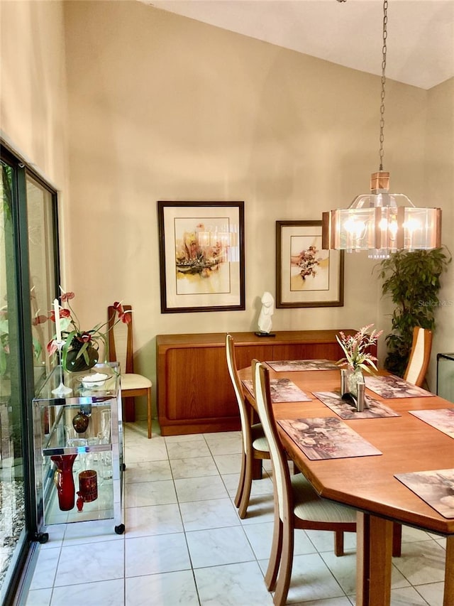 3407 Avenida Madera Unit A, Bradenton, FL 34210 - dining area featuring a chandelier, high vaulted ceiling, and light marble finish floors