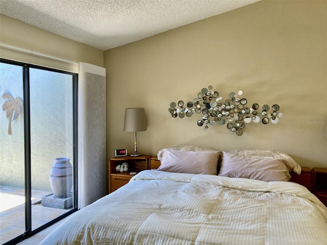 3407 Avenida Madera Unit A, Bradenton, FL 34210 - bedroom featuring access to outside and a textured ceiling