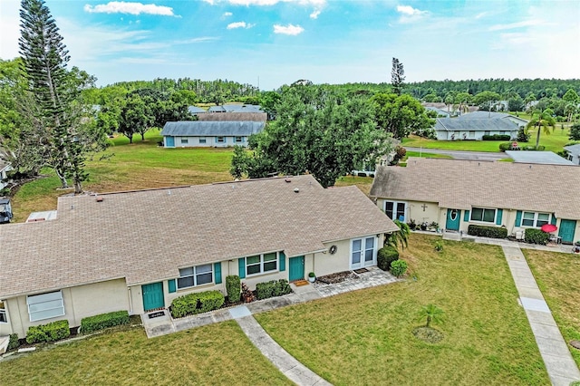 1906 Canterbury Ln Unit 16, Sun City Center, FL 33573 - ranch-style house featuring a residential view, stucco siding, and a front lawn