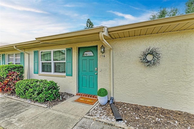 1906 Canterbury Ln Unit 16, Sun City Center, FL 33573 - doorway to property featuring stucco siding