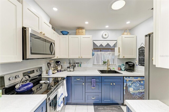 1906 Canterbury Ln Unit 16, Sun City Center, FL 33573 - kitchen featuring stainless steel appliances, a sink, light countertops, white cabinetry, and recessed lighting