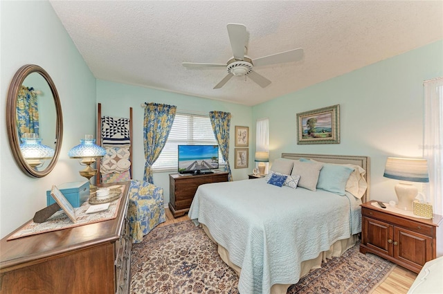 1906 Canterbury Ln Unit 16, Sun City Center, FL 33573 - bedroom with light wood-style flooring, a textured ceiling, and ceiling fan