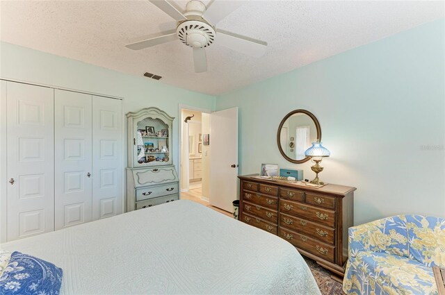 1906 Canterbury Ln Unit 16, Sun City Center, FL 33573 - bedroom with a textured ceiling, a closet, and ceiling fan