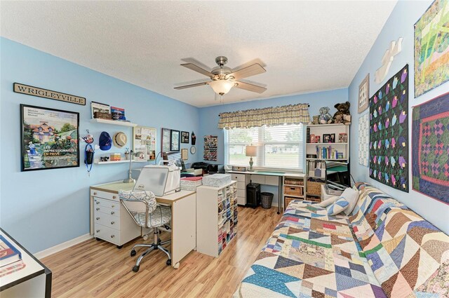1906 Canterbury Ln Unit 16, Sun City Center, FL 33573 - home office featuring light wood-type flooring, a ceiling fan, and a textured ceiling