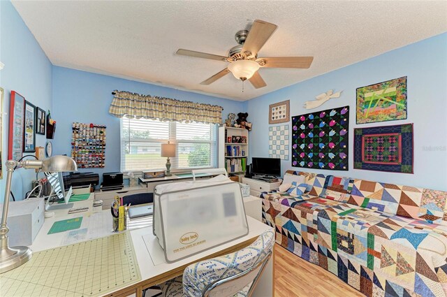 1906 Canterbury Ln Unit 16, Sun City Center, FL 33573 - bedroom featuring a textured ceiling, an office area, and a ceiling fan