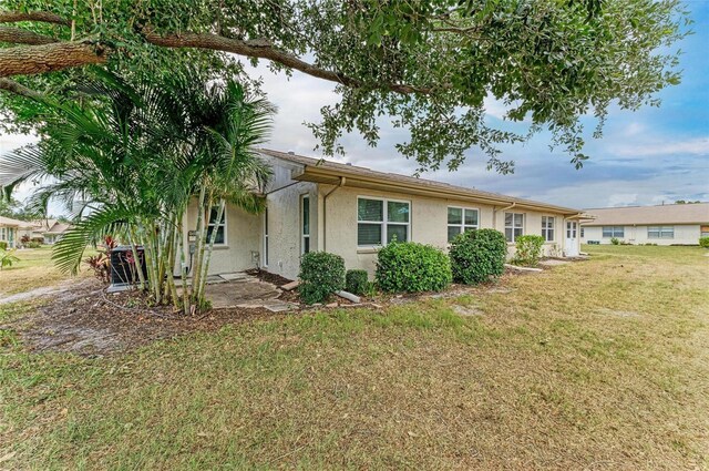 1906 Canterbury Ln Unit 16, Sun City Center, FL 33573 - view of front of home with stucco siding and a front lawn