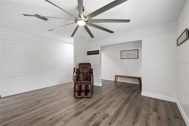 2255 61st St, Sarasota, FL 34243 - sitting room with baseboards, wood finished floors, wood walls, and ceiling fan